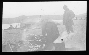 Image of Camp site. 2 White men by steaming can